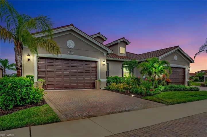 Mediterranean / spanish-style home with decorative driveway, a garage, stucco siding, and a tiled roof