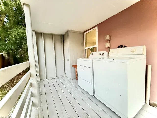 Laundry area featuring separate washer and dryer and light wood-type flooring