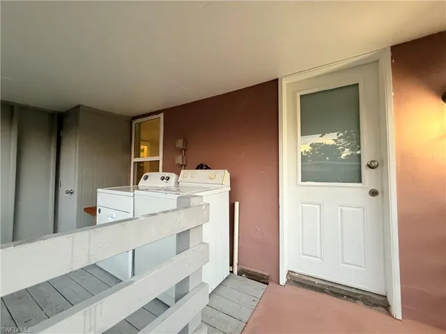 Side Doorway to property featuring independent washer and dryer