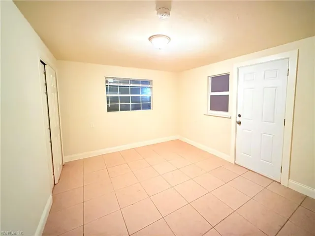 Spare room featuring light tile patterned floors and a smoke detector