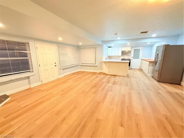 Unfurnished living room with light wood-style flooring and recessed lighting