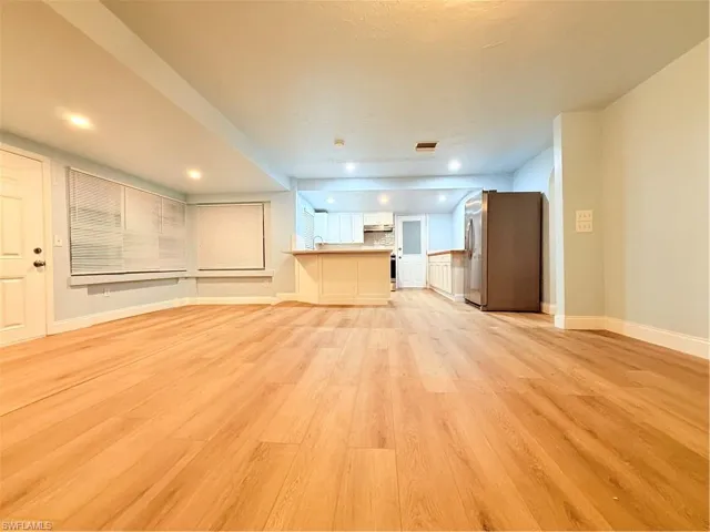 Unfurnished living room featuring light wood-type flooring and recessed lighting