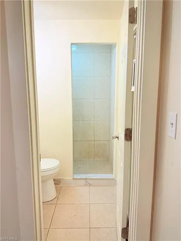 Bathroom featuring a tile shower and tile patterned flooring