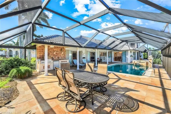 View of swimming pool with area for grilling, a sunroom, a lanai, a patio, and a pool with connected hot tub