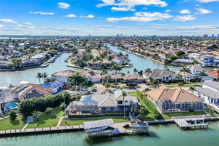 Aerial perspective of suburban area featuring a nearby body of water