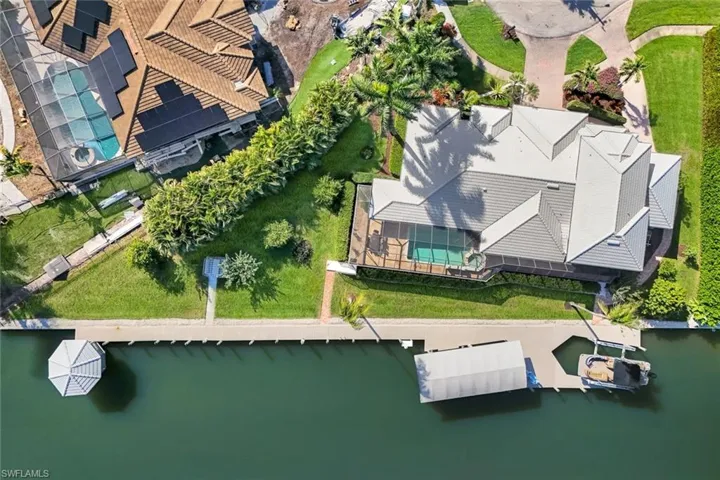 Aerial view of property and surrounding area with a large body of water