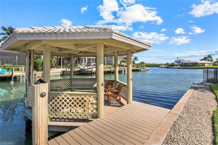 Dock area with a water view and boat lift