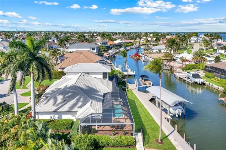 Aerial perspective of suburban area featuring a nearby body of water