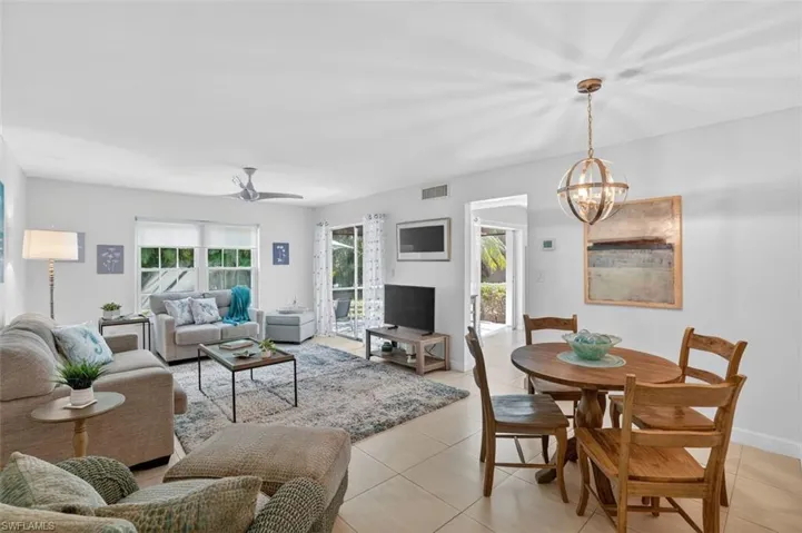 Living - dining room combination with ceiling fan and double sliders to the lanai