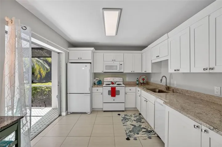 Kitchen with double sliders to screened-in lanai