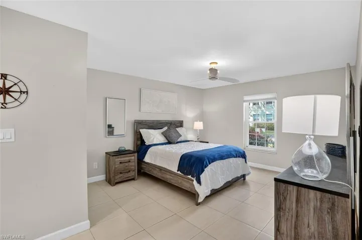 Main Bedroom featuring light tile patterned floors and ceiling fan