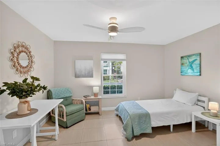 2nd bedroom with ceiling fan and double closet