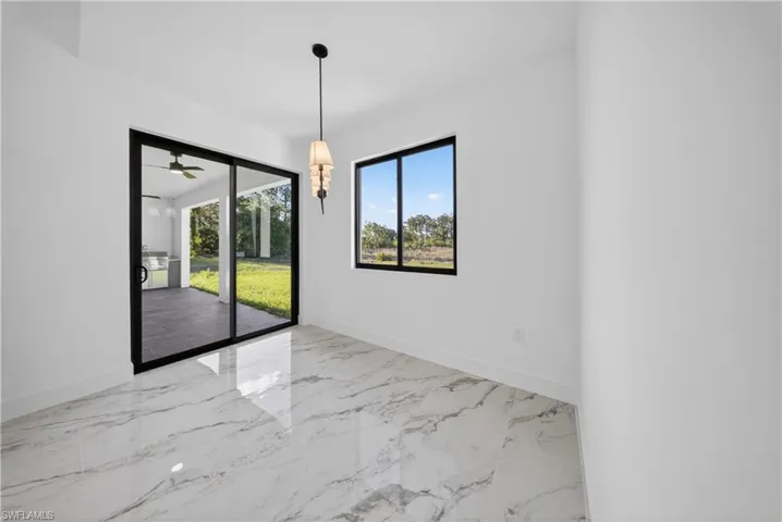 Empty room featuring baseboards and light marble finish floors
