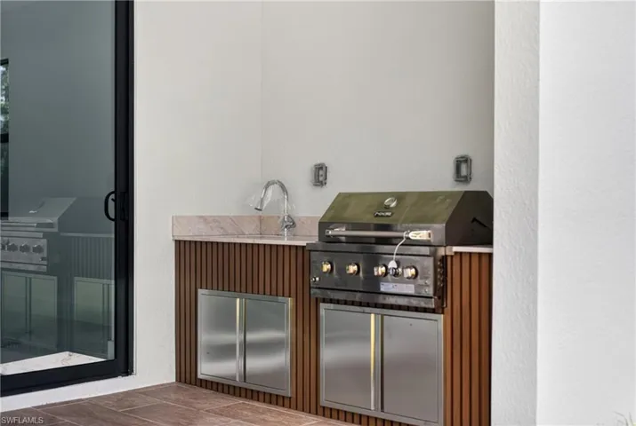 View of patio featuring area for grilling