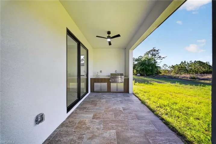 View of patio / terrace featuring an outdoor kitchen and ceiling fan