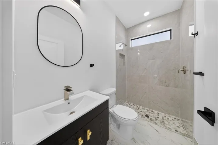 Full bath with vanity, a stall shower, and recessed lighting