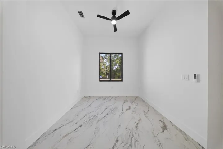 Unfurnished room featuring baseboards and ceiling fan