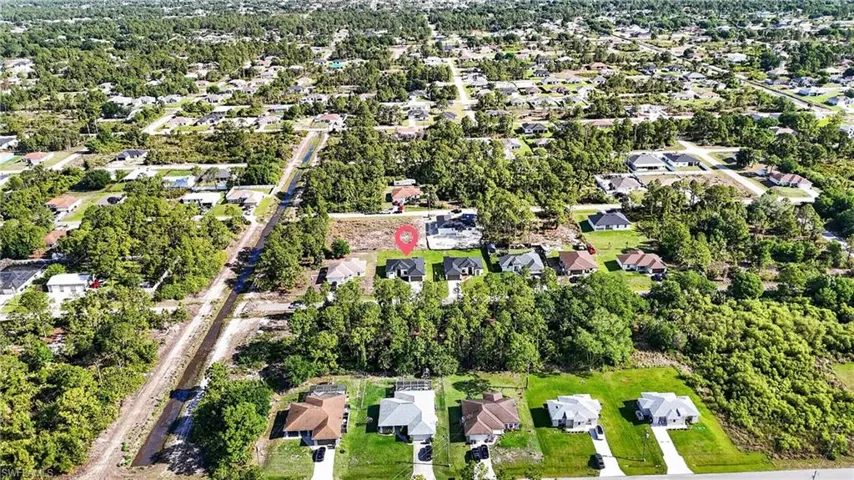 Aerial perspective of suburban area featuring a tree filled landscape