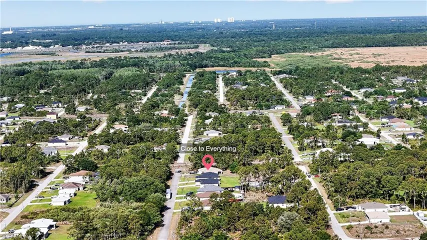 Aerial view of property and surrounding area with nearby suburban area