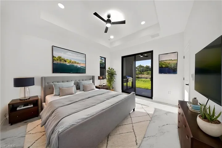 Bedroom with ceiling fan, access to exterior, and recessed lighting