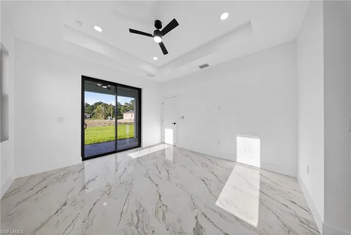 Empty room featuring recessed lighting, ceiling fan, and light marble finish floors