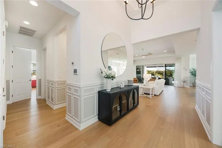 First impressions! High ceilings, grand scale lighting fixtures, wood flooring, and custom wall trim treatments set a warm and welcoming tone from the moment you walk through the door.