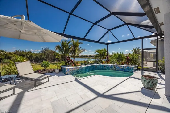 12128 Eucalyptus Way enjoys TWO views from the outdoor living space! Landscaped preserve to the left;  lake views to the right.