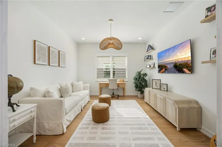 The den is located just off of the foyer, with a double door-width entrance and wood flooring. This spot is perfectly tucked away to provide a place to work, watch a movie, or read a great book.