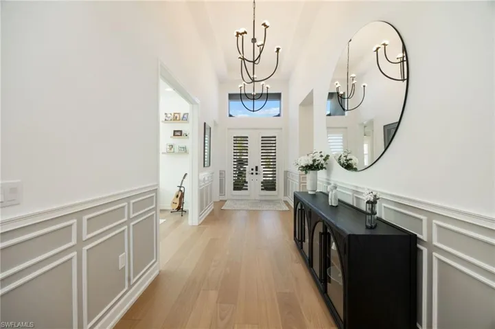 First impressions! High ceilings, grand scale lighting fixtures, wood flooring, and custom wall trim treatments set a warm and welcoming tone from the moment you walk through the door.