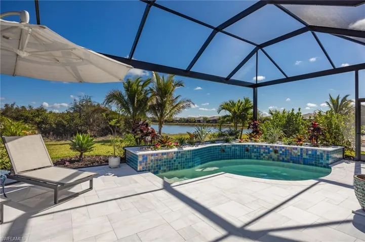12128 Eucalyptus Way enjoys TWO views from the outdoor living space! Landscaped preserve to the left;  lake views to the right.