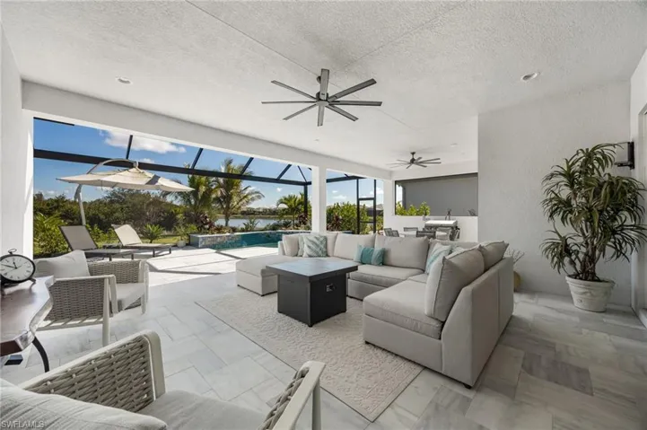 The extended covered living area and stone travertine paver pool deck elevate this outdoor living space and set the stage to enjoy indoor outdoor living!