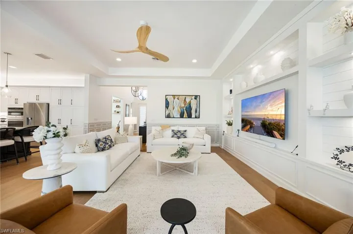 The custom wall feature in the great room feels grounded and inviting. Impact sliders lead out to the outdoor living area - this is seamless indoor/outdoor living!