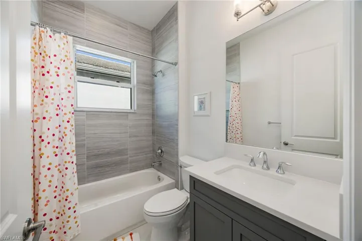 En-suite Bathroom 3 offers a second tub and ample light and storage.