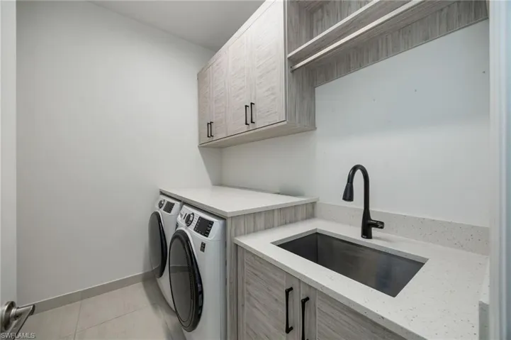 Even the laundry room feels special! Cabinetry on both sides of the room offer storage, long hanging, and full height cabinets (perfect for vaccuum or broom storage)