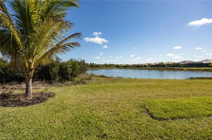 12128 Eucalyptus Way enjoys TWO views from the outdoor living space! Landscaped preserve to the left;  lake views to the right.