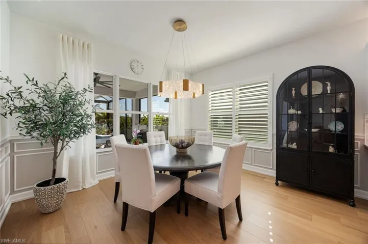 The dining area is just off of the kitchen with large windows looking out to the lake view.