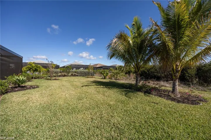 12128 Eucalyptus Way enjoys TWO views from the outdoor living space! Landscaped preserve to the left;  lake views to the right.