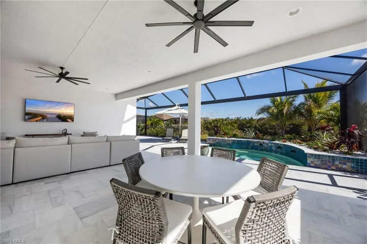 The extended covered living area and stone travertine paver pool deck elevate this outdoor living space and set the stage to enjoy indoor outdoor living!