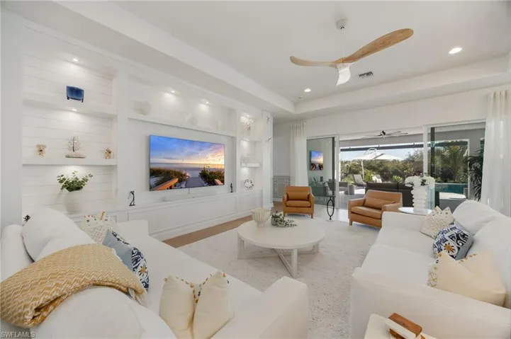 The custom wall feature in the great room feels grounded and inviting. Impact sliders lead out to the outdoor living area - this is seamless indoor/outdoor living!