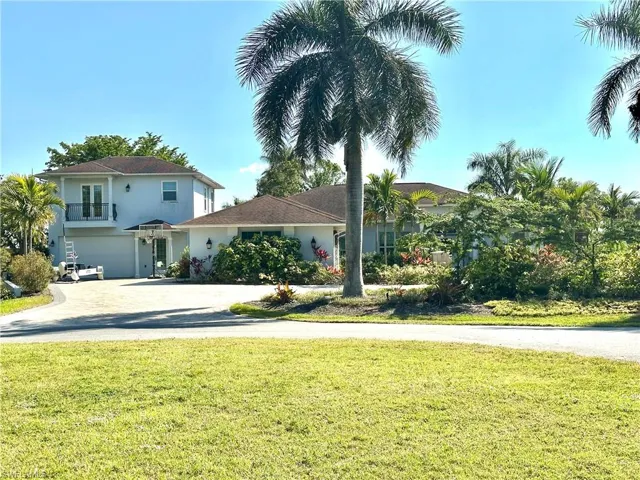 View of front of property with garages and front yard