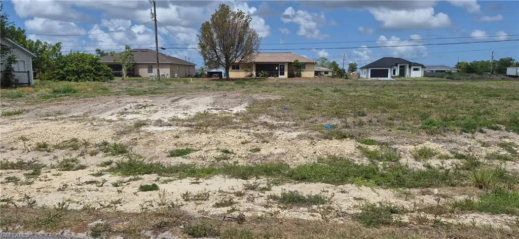 Expansive undeveloped land featuring natural ground cover and clear skies