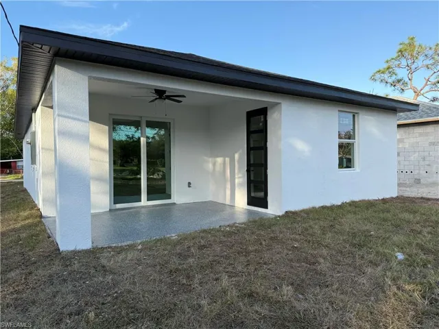 Rear view of property with ceiling fan