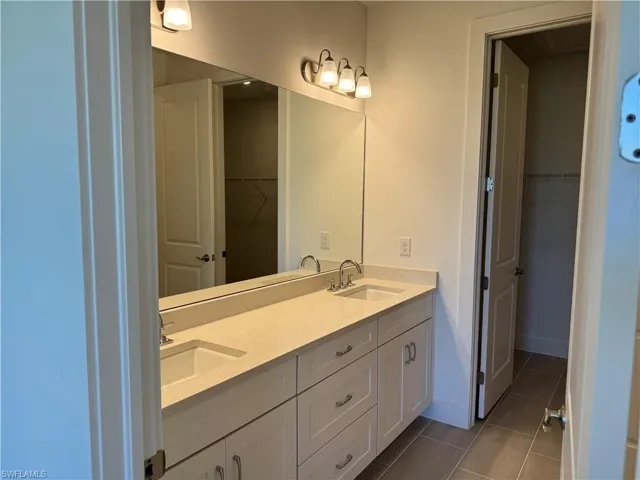 Primary bathroom with dual-sinks, quartz countertops and soft-close cabinetry