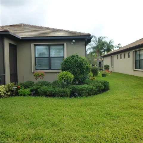 View of side of home featuring a yard