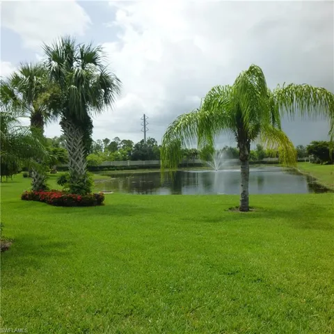 View of home's community featuring a water view and a yard