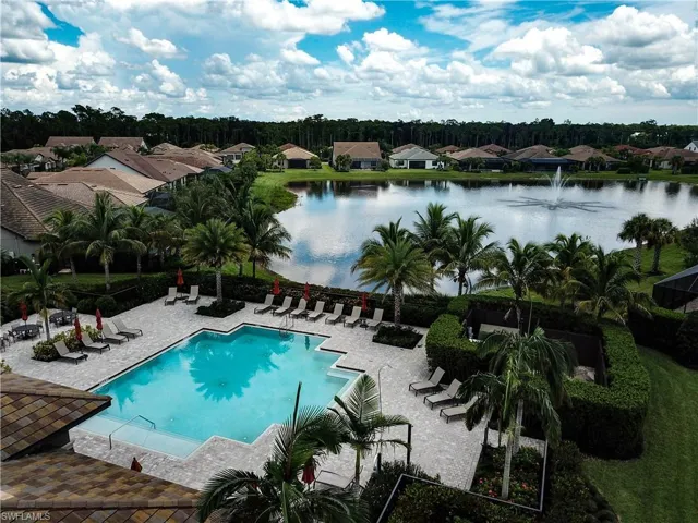 View of pool with a water view and a patio area