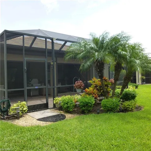 View of yard featuring glass enclosure