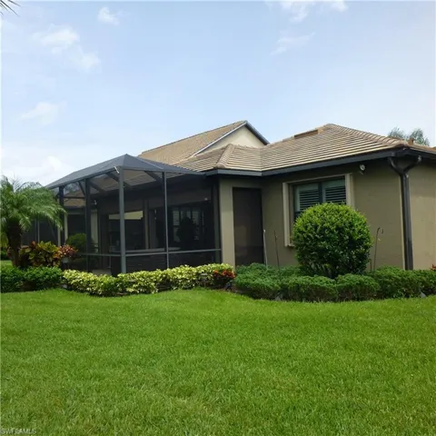 Back of house with a lawn