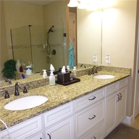 Bathroom with double sink vanity and an enclosed shower