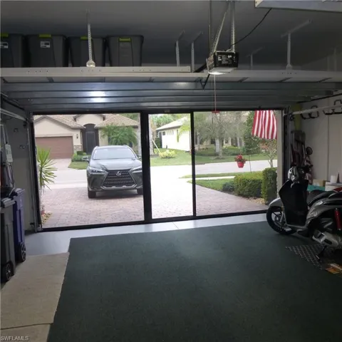 Garage featuring a garage door opener
